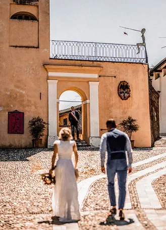 Bride and groom walking through an Italian street