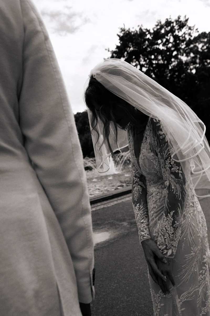 Wedding couple seen from behind on a path, black-and-white photograph