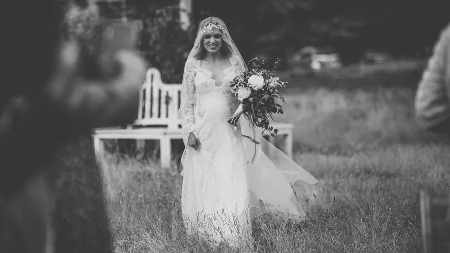 Bride and groom during an outdoor ceremony, in black and white