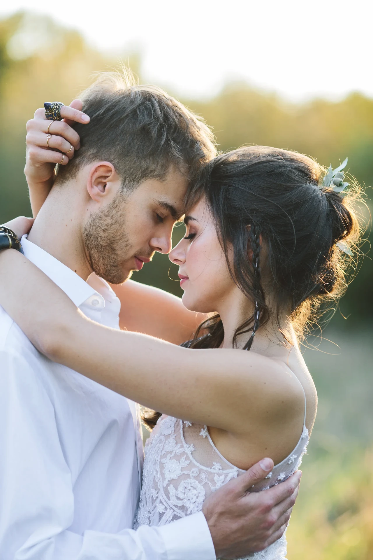 Wedding couple walking hand in hand through a meadow