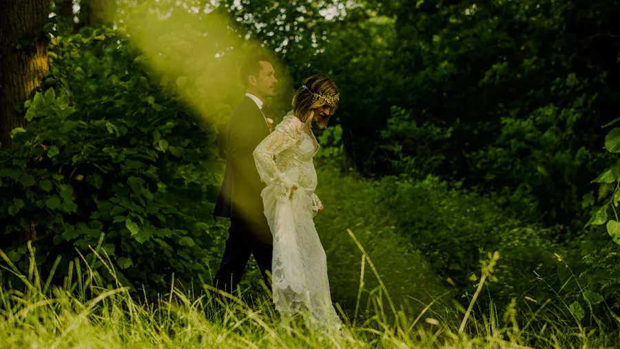 Bride in a white dress among tall grasses