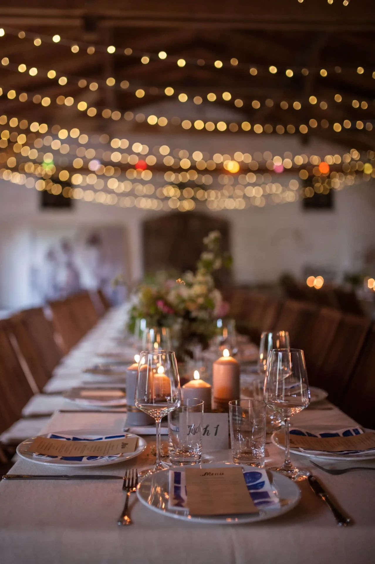 Festive barn dining table with candles and flowers