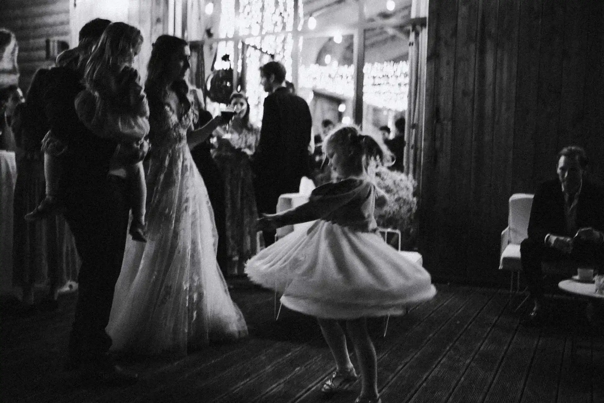 Guests celebrating and dancing at a wedding, black-and-white photograph