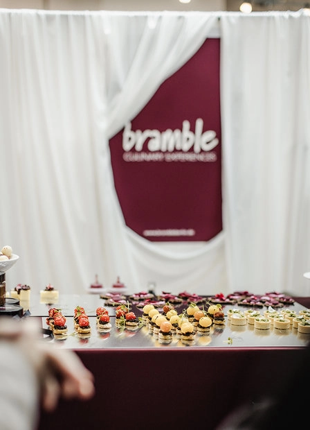 Fabric banner with red lettering at a stand