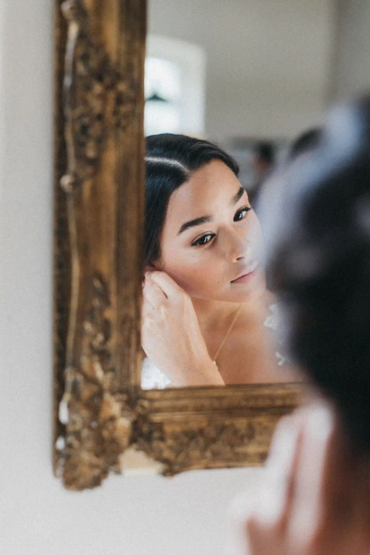 Bride looking at herself in a mirror
