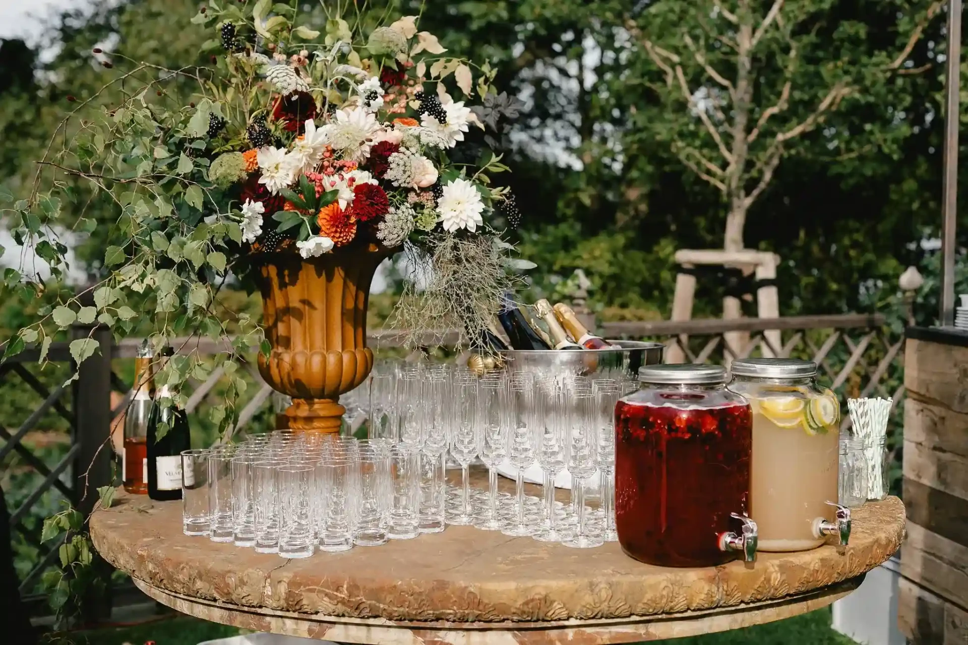 Floral arrangement and drinks station on a garden table