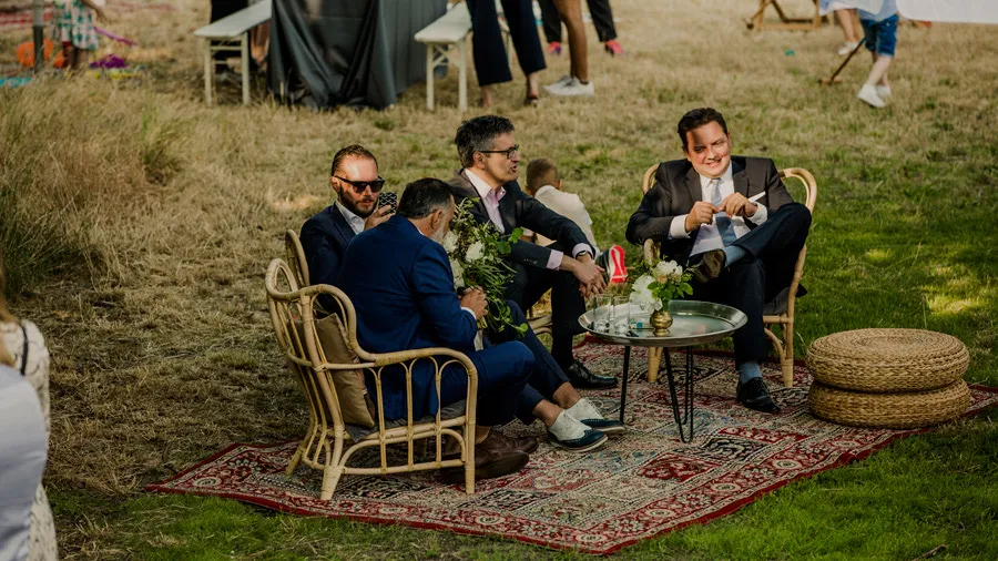 Guests seated on lounge chairs in the garden