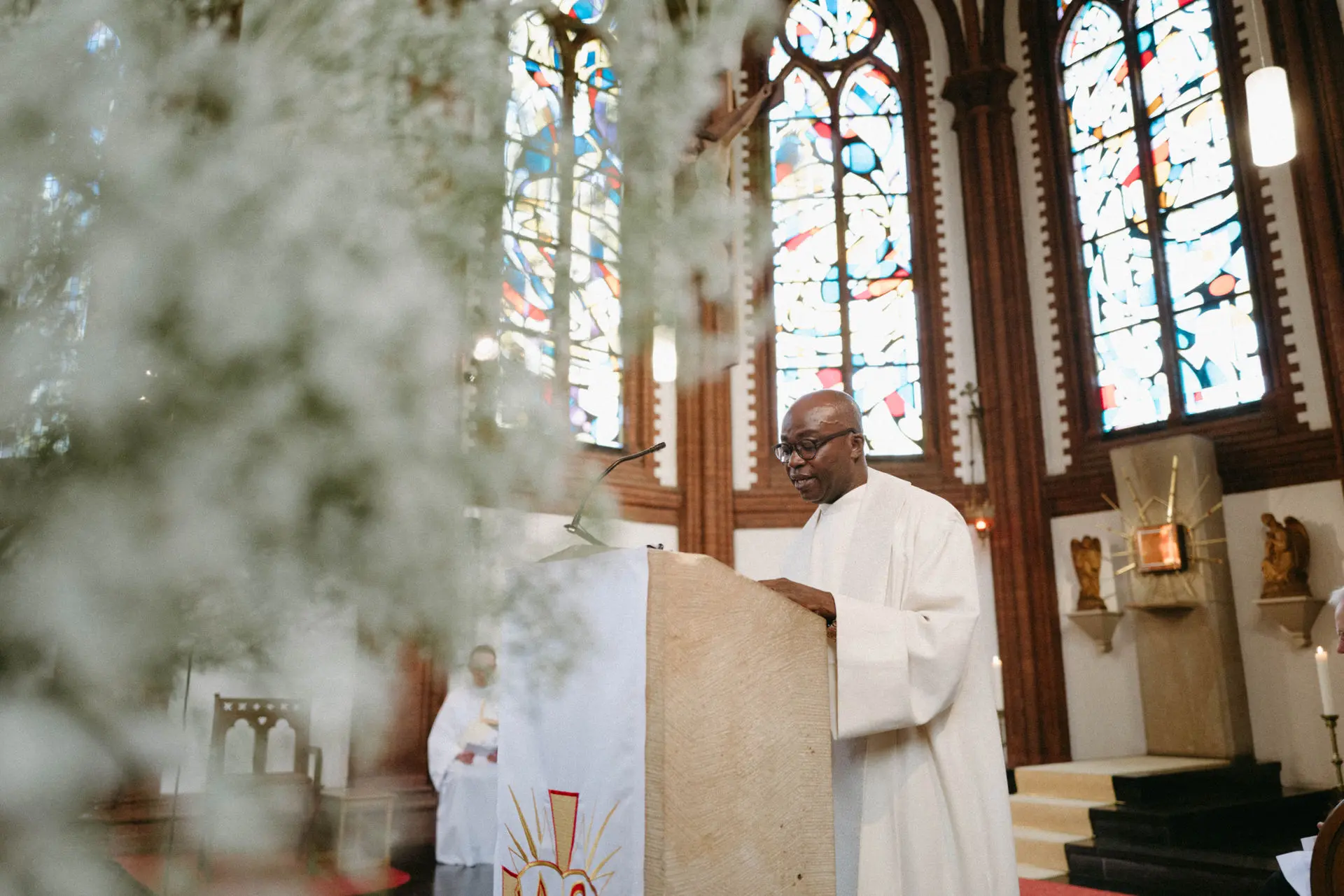 Wedding couple during the ceremony in a church with tall windows