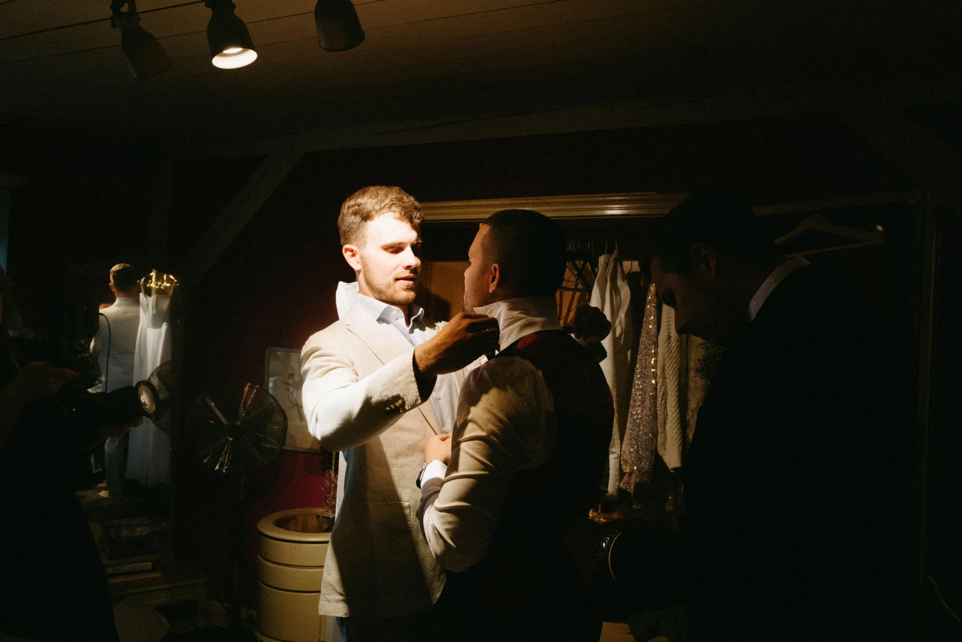 Bride and groom dancing at a celebration in a dimly lit room