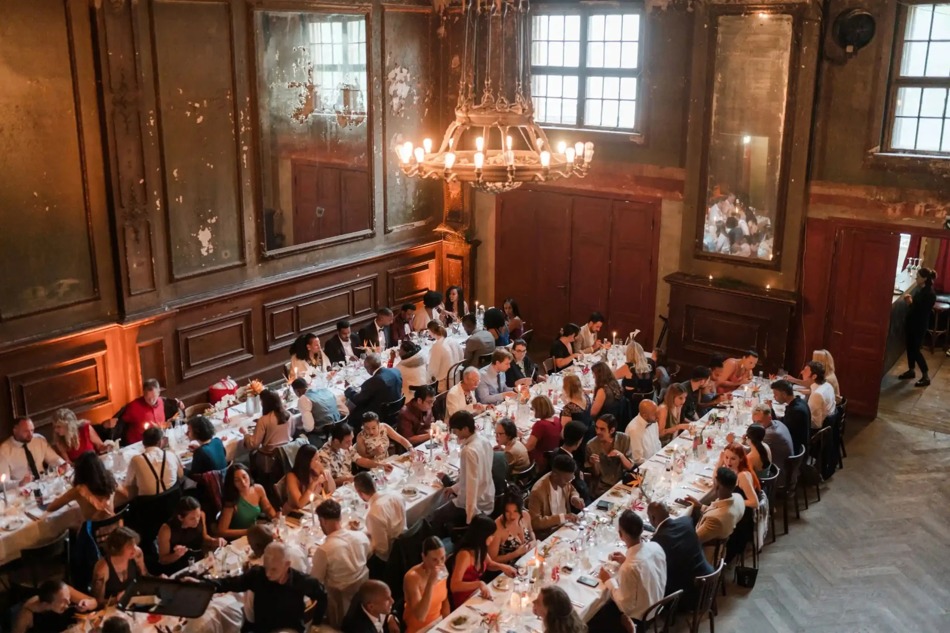 Overhead view of a wedding table and guests in a historic hall