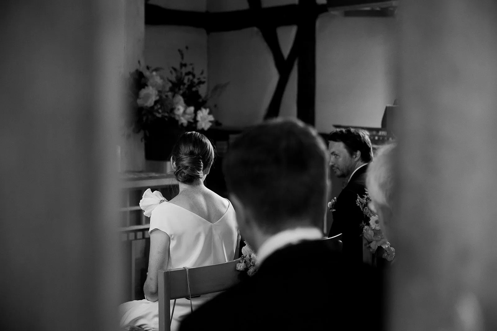 Black-and-white photograph of guests during the ceremony