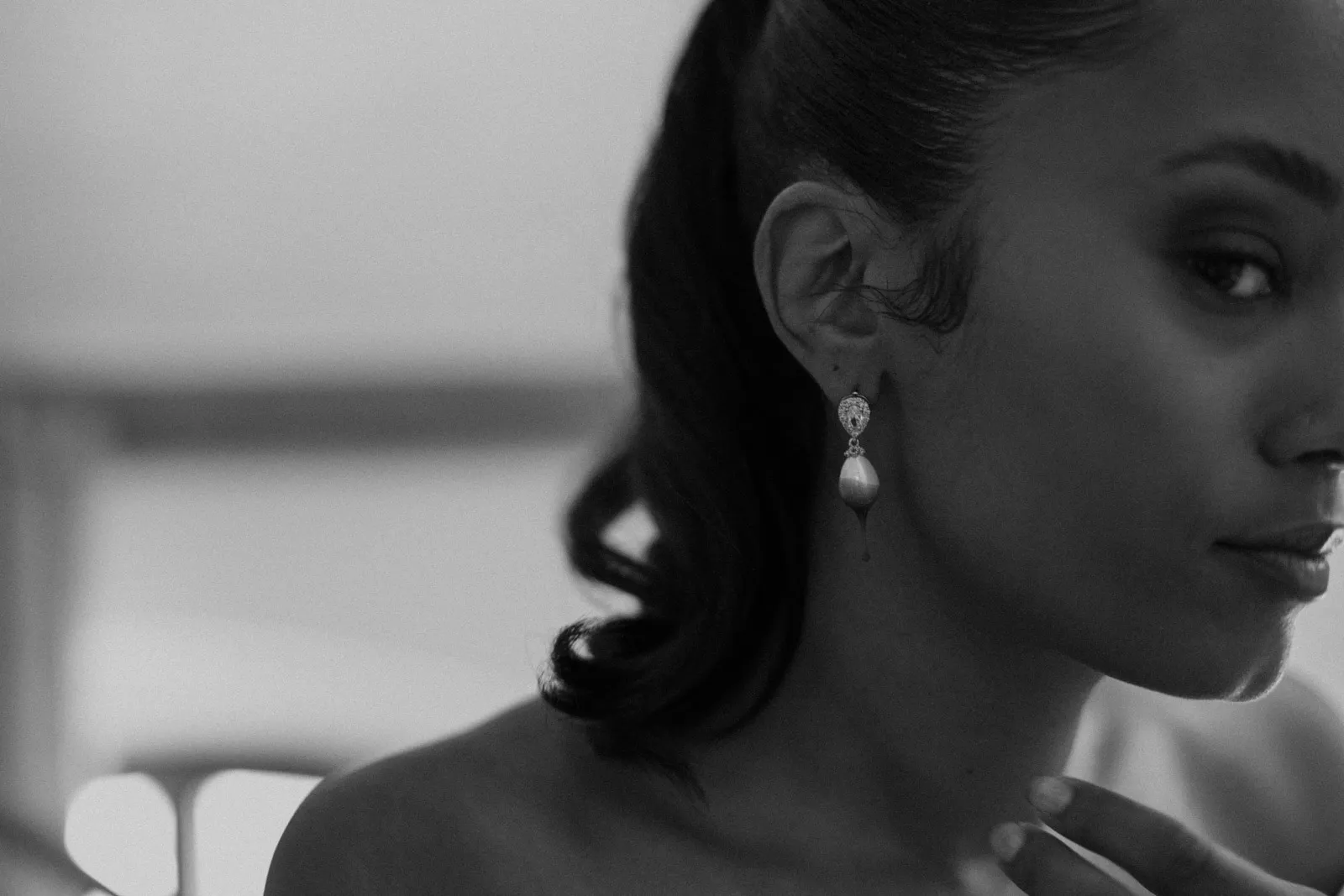 Black-and-white portrait of the bride wearing a pearl earring