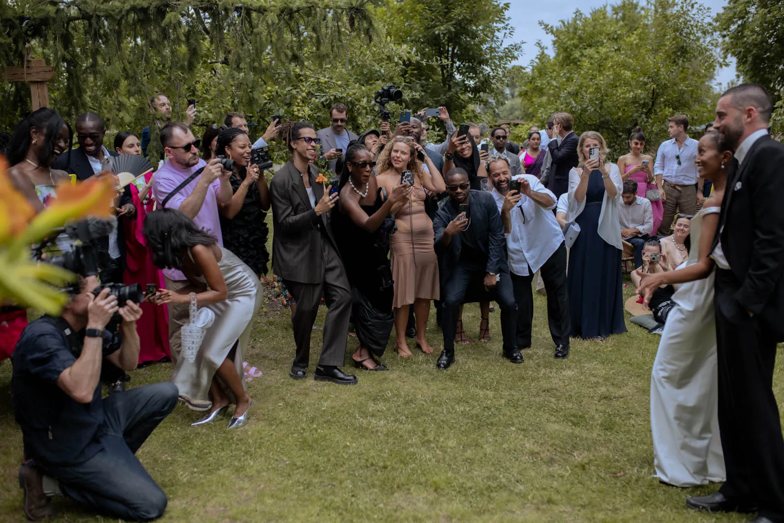 Wedding guests gathered in a meadow during a wedding game