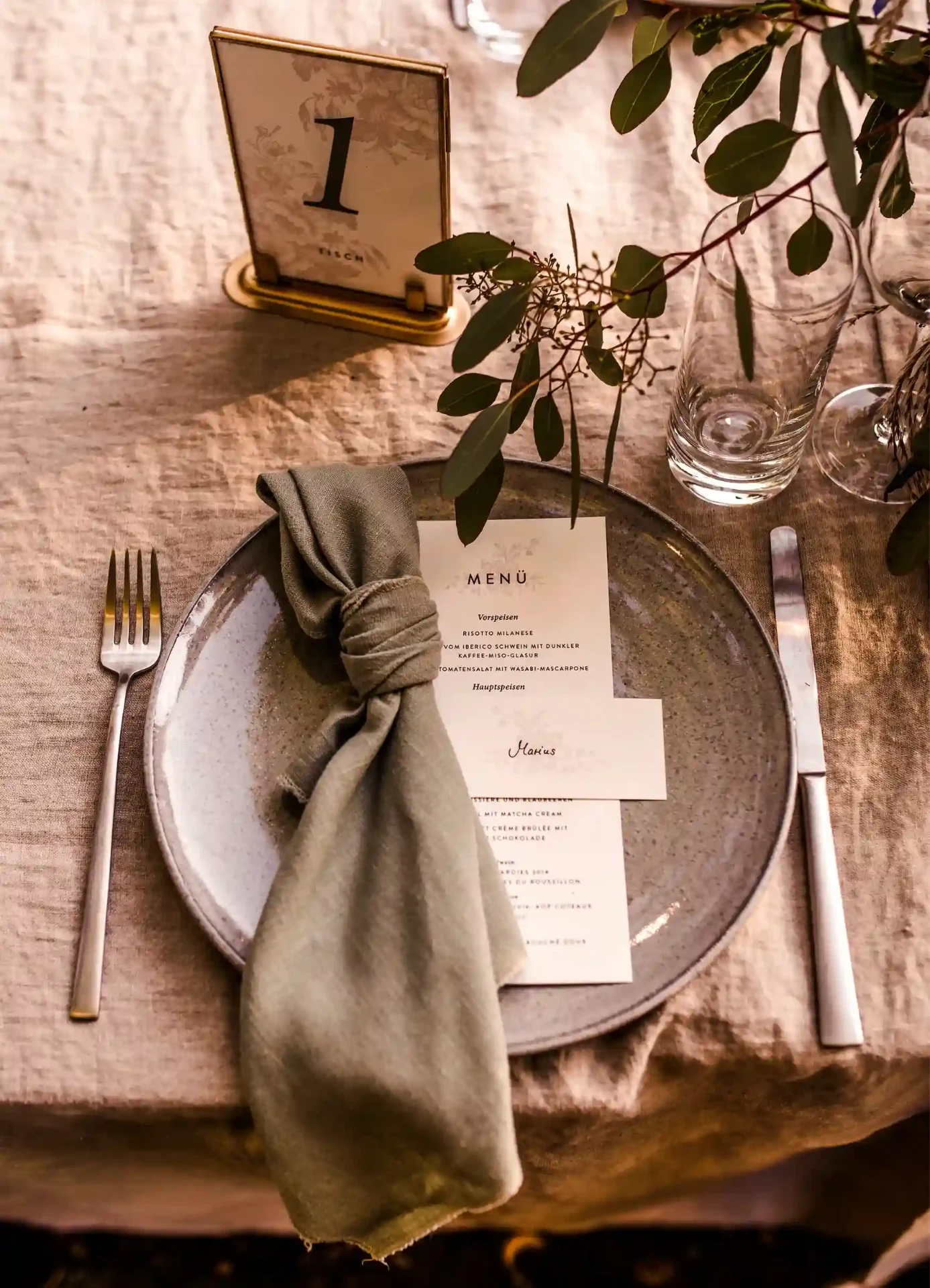 Detail of a wedding table with a cloth napkin and menu card