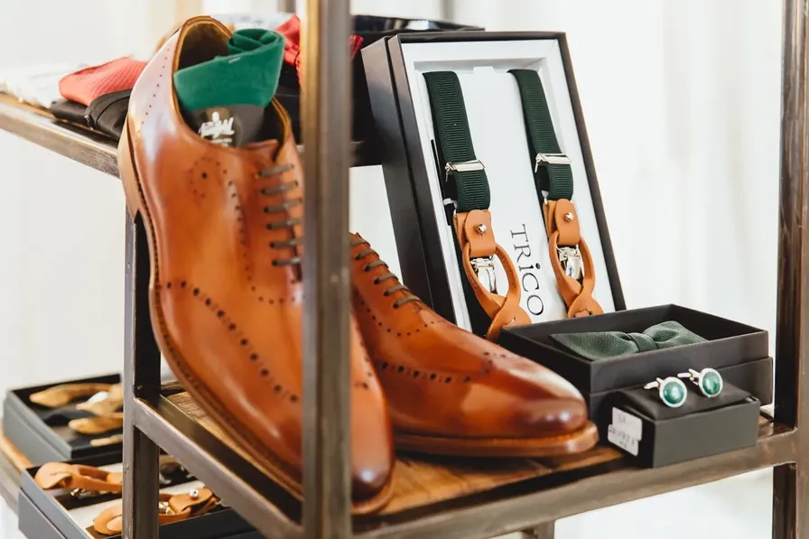 Brown leather shoes and accessories displayed in a presentation box