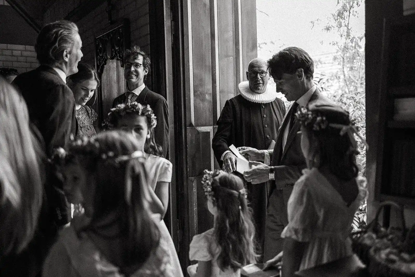 Black-and-white photograph of guests during a church wedding ceremony