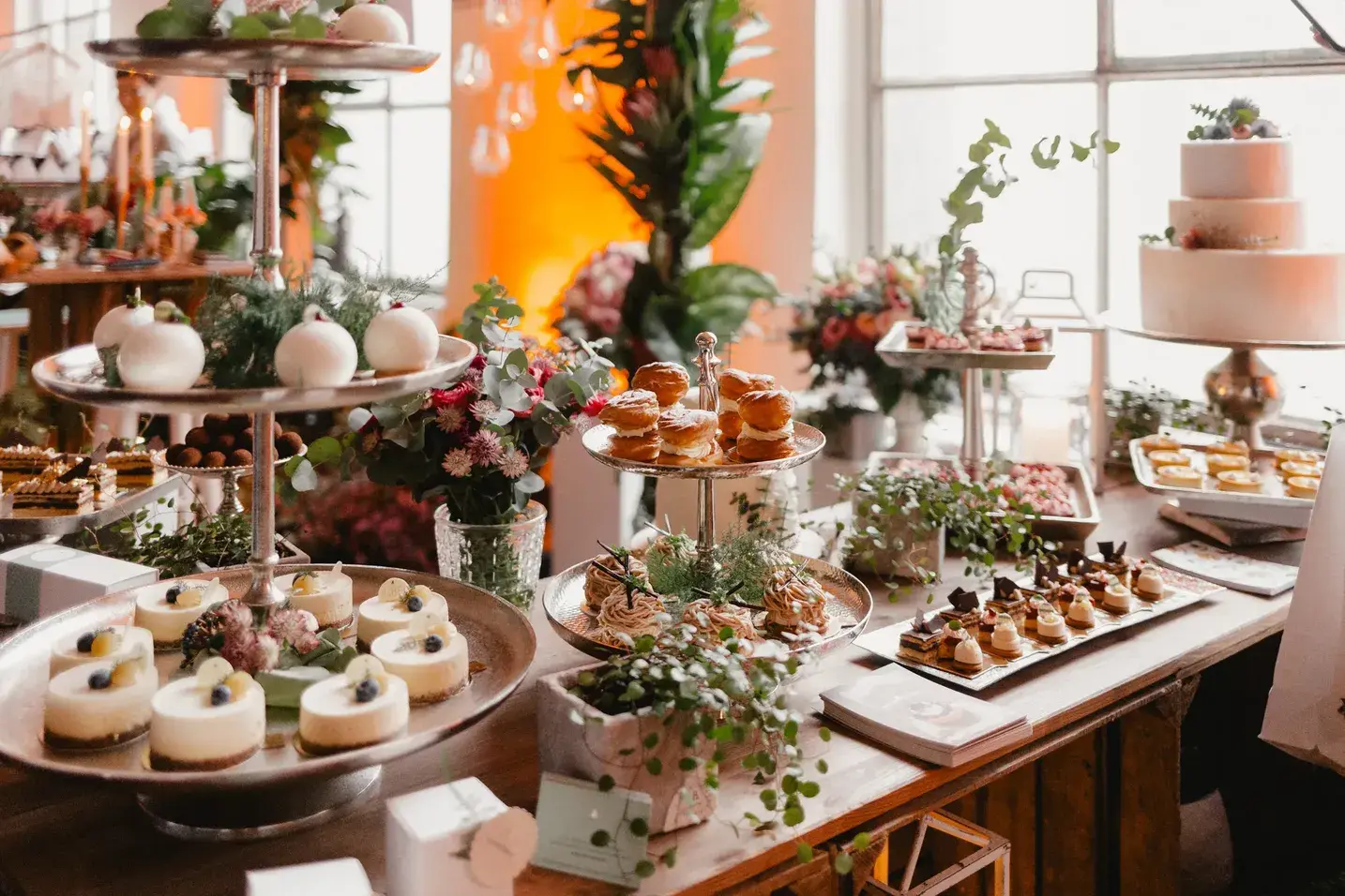 Dessert buffet with small cakes and floral decorations