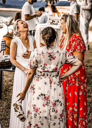 Wedding couple with guests at an outdoor celebration