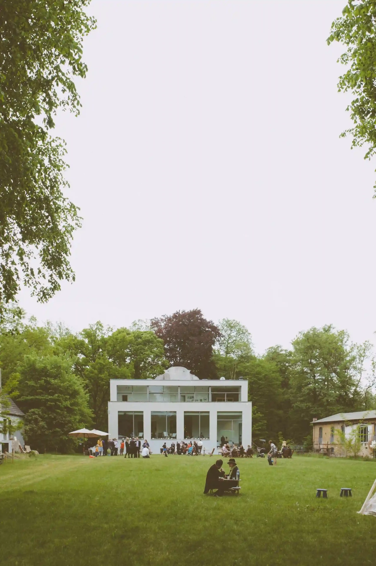 White building at the edge of a green lawn