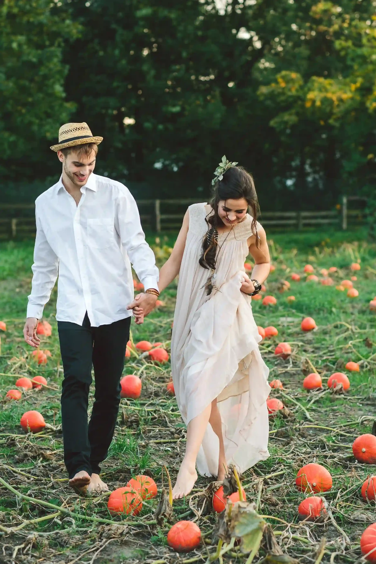 Bride and groom sitting together on a rustic cart beneath trees