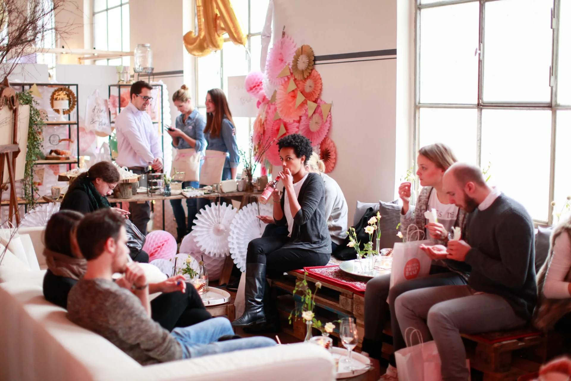 Guests seated at tables in a bright room with large windows