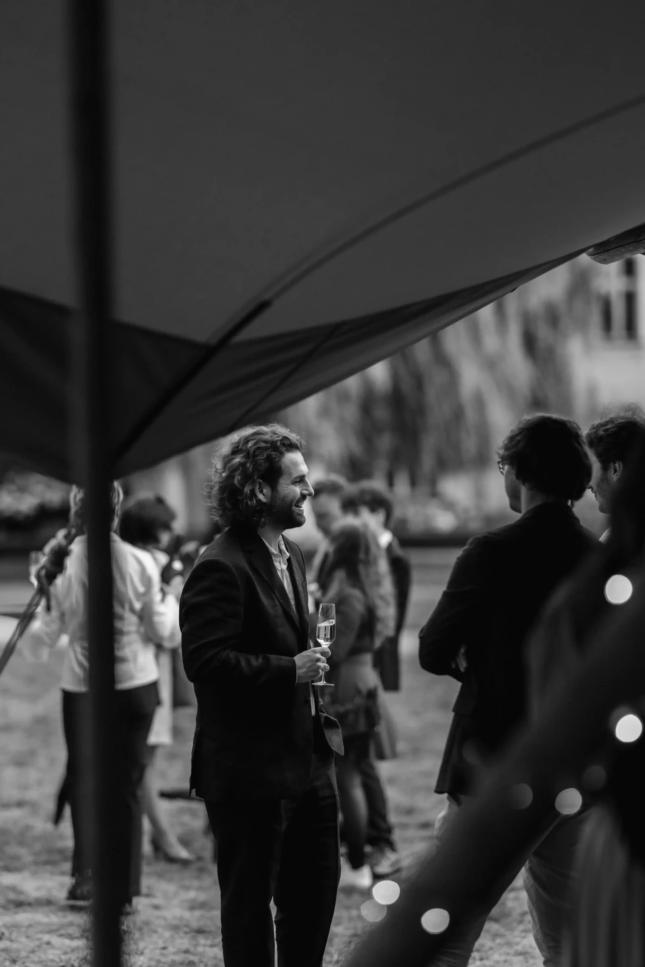 Bride and groom with guests at an outdoor celebration