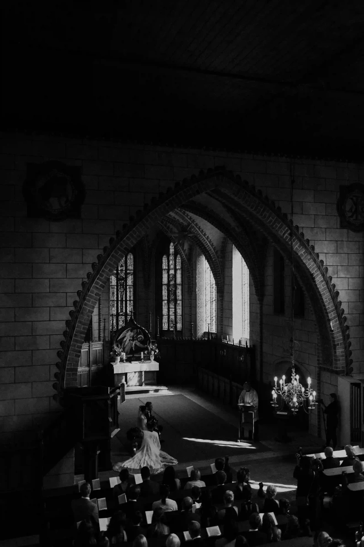 Black-and-white photograph of the bride and groom in a church