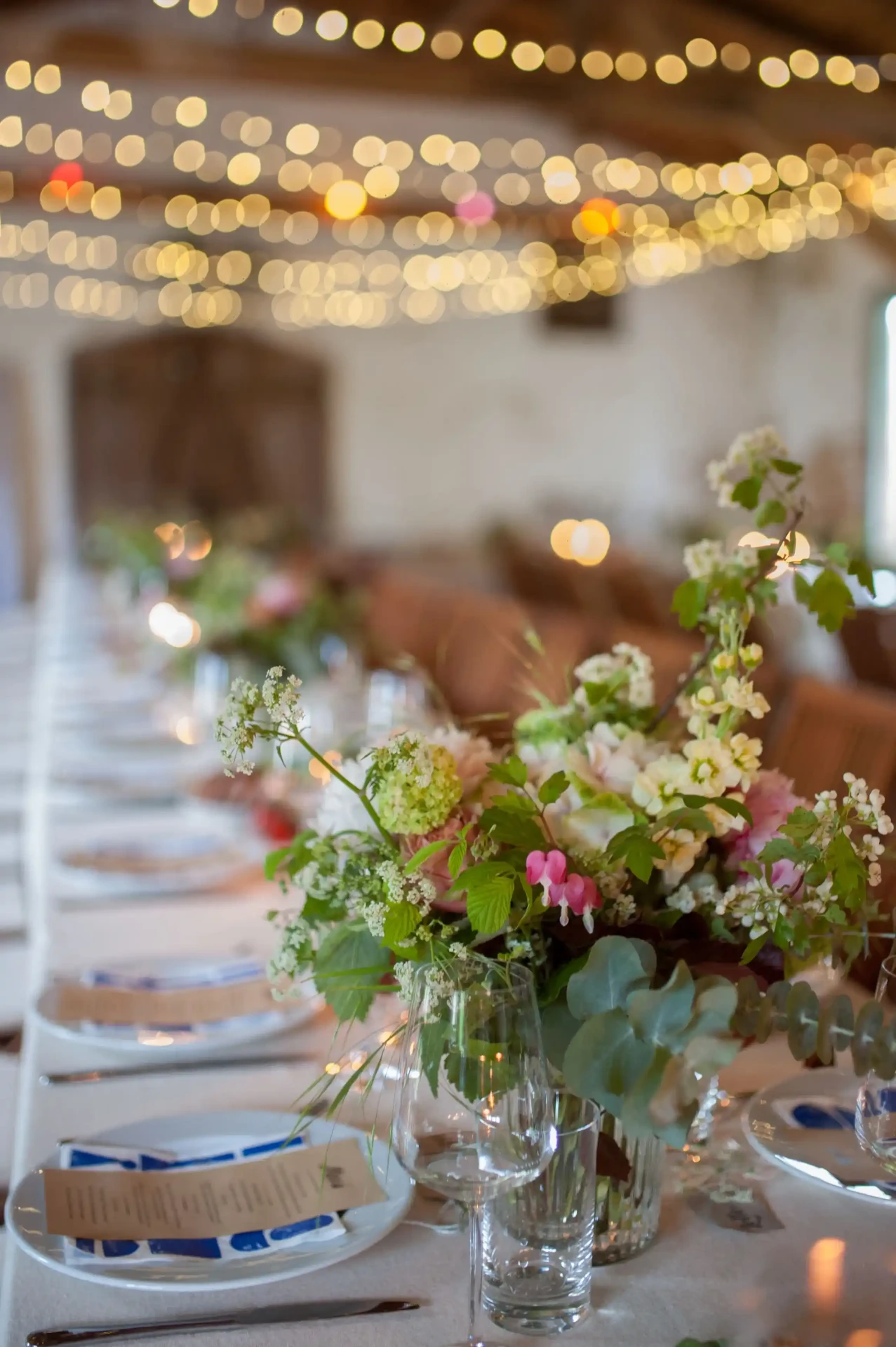 Wedding table with a floral arrangement in a rustic barn