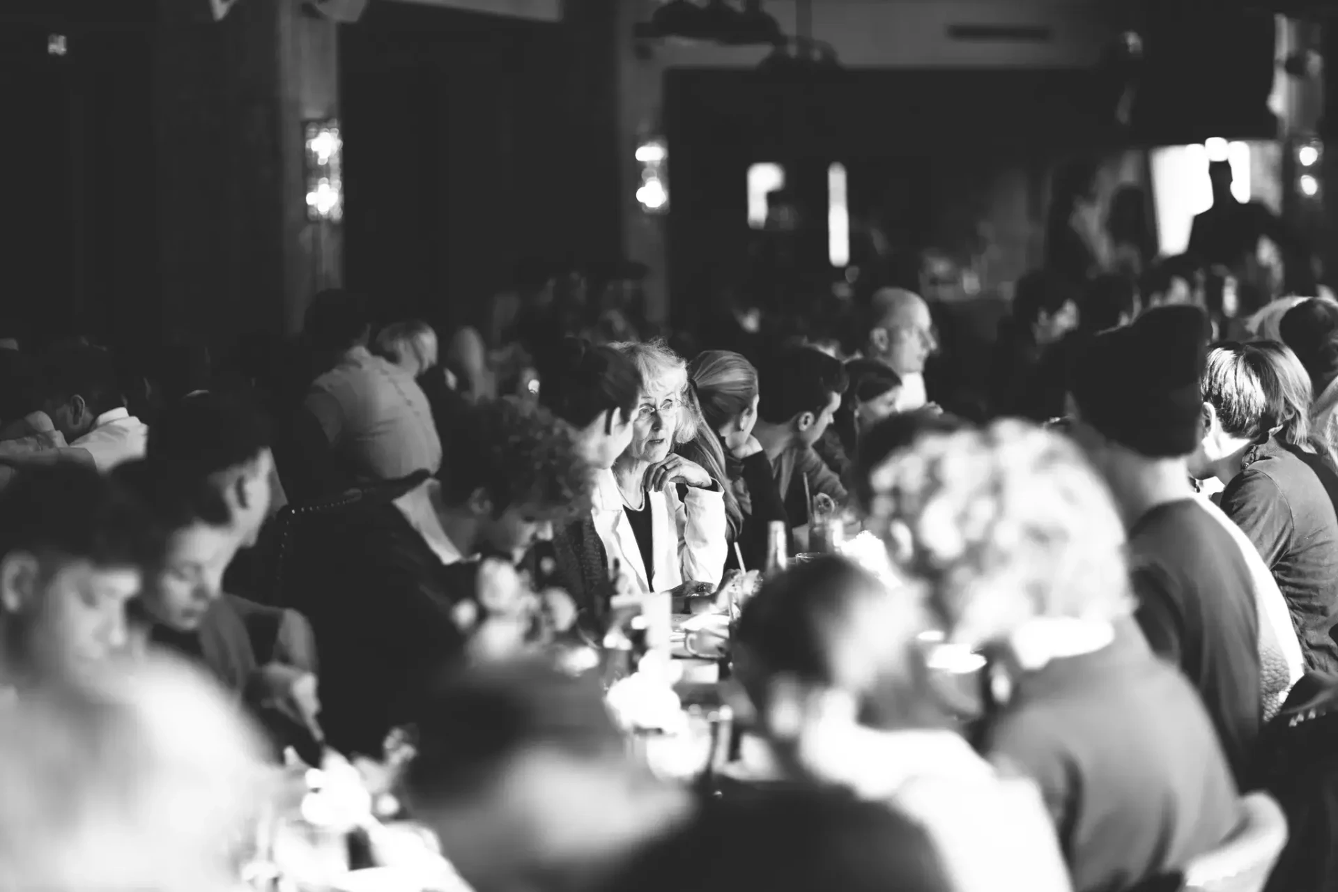 Guests seated at a celebration, black-and-white photograph