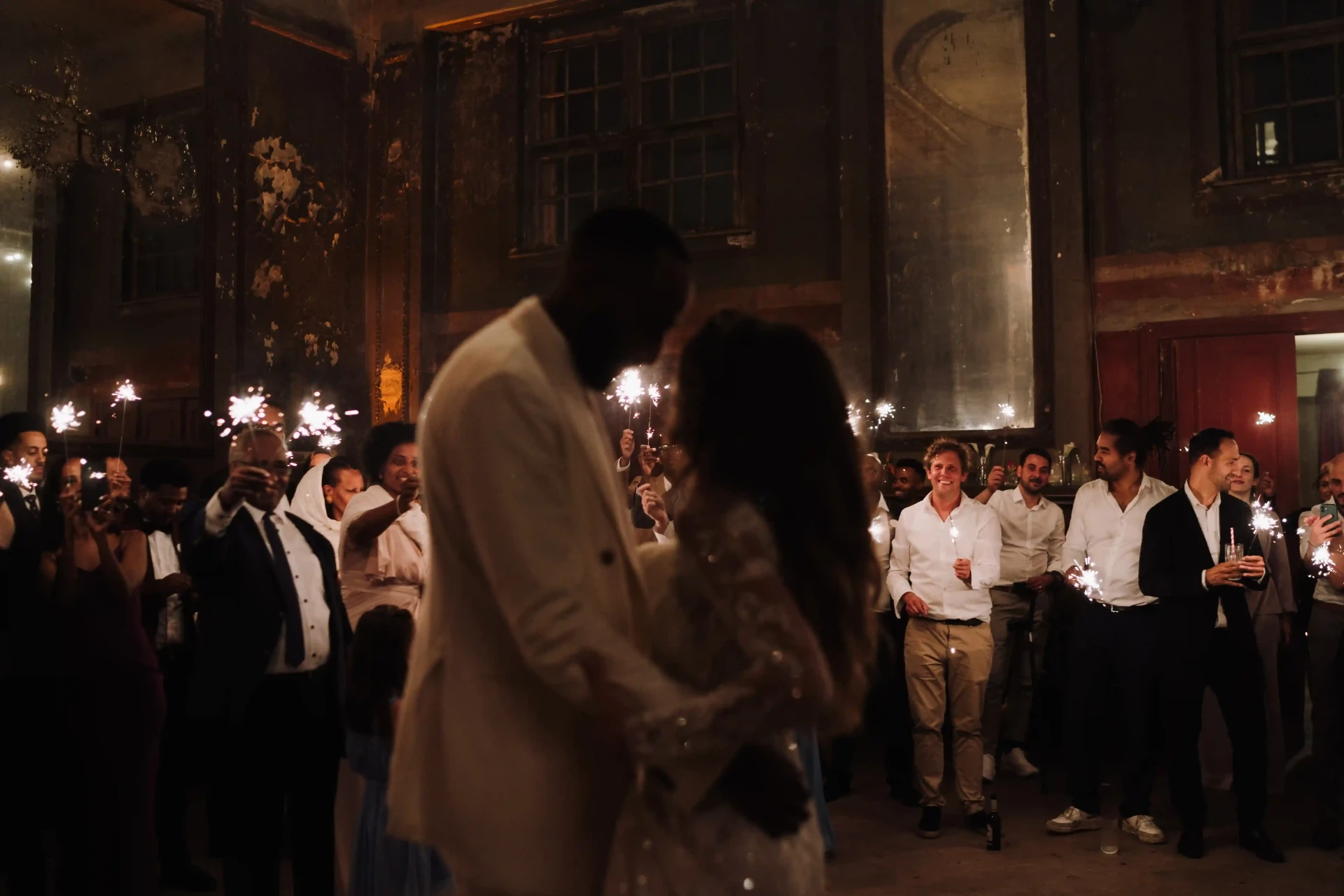 Wedding couple dancing in a festively illuminated historic hall