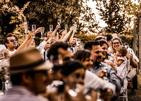 Wedding guests seated at a long outdoor table