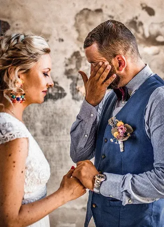 Wedding couple in colourful outfits during a ceremony