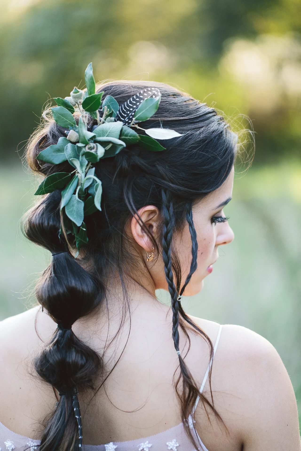Detail of the bride’s braided hairstyle with floral hair accessories