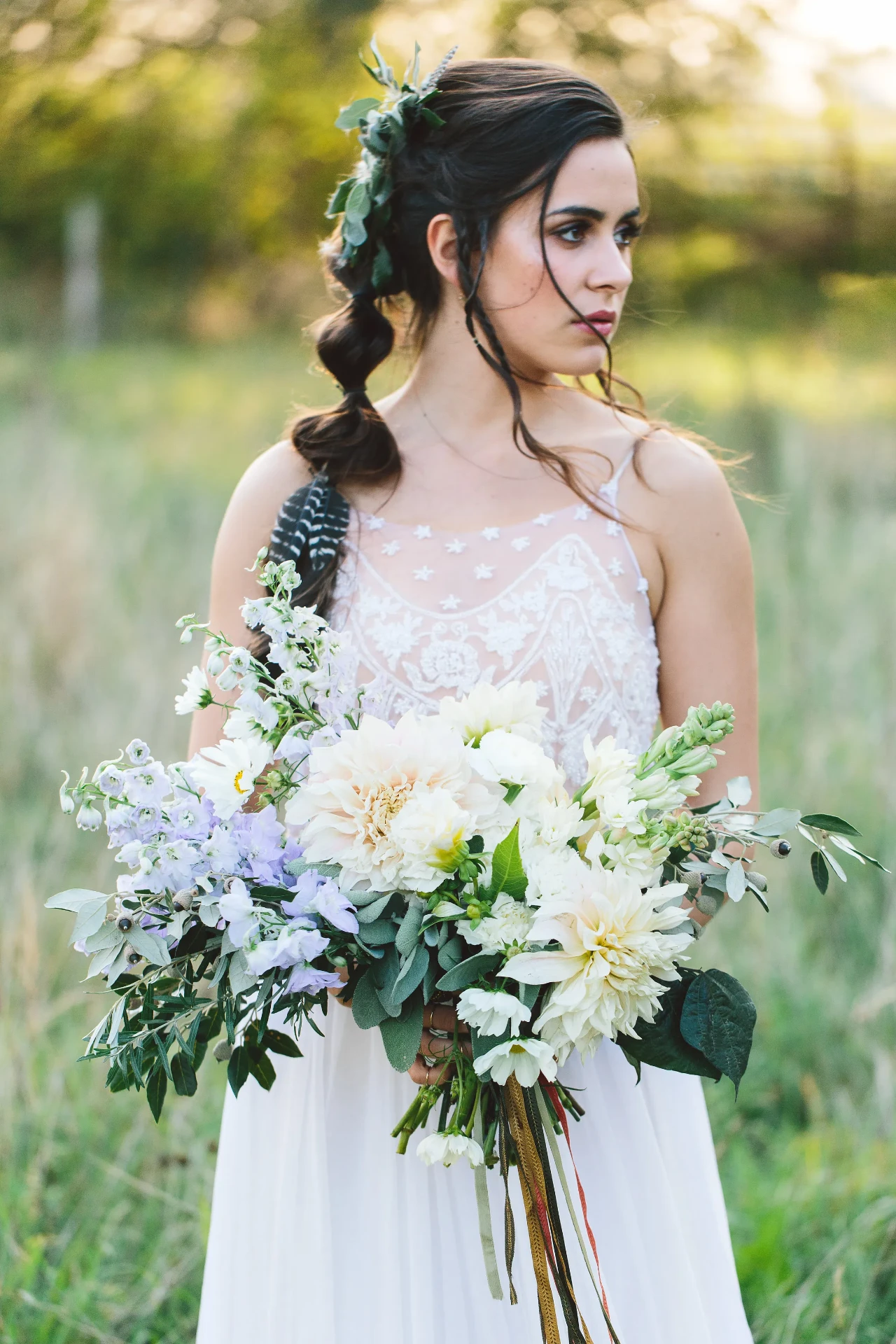 Dark-haired bride holding a large white bouquet