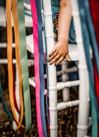 Colourful ribbons hanging from a ladder