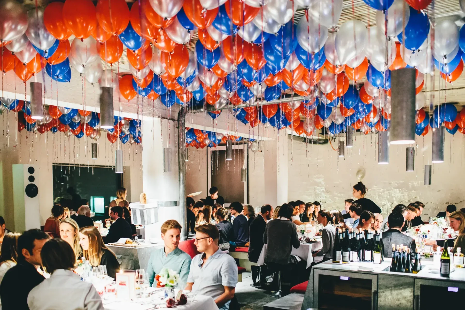 Guests seated at long tables in a festively decorated room