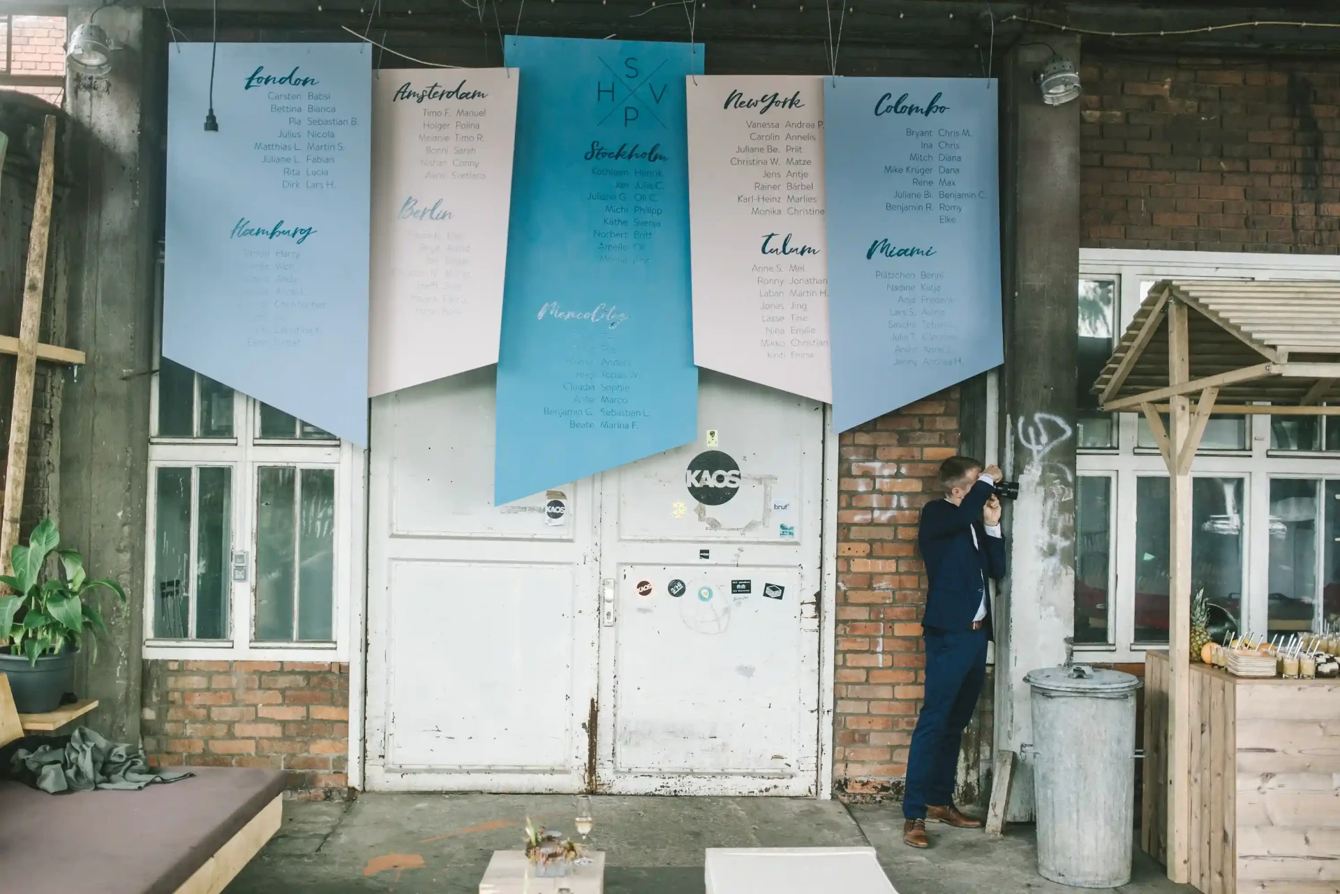 Cards and plans displayed on a brick wall inside a workshop