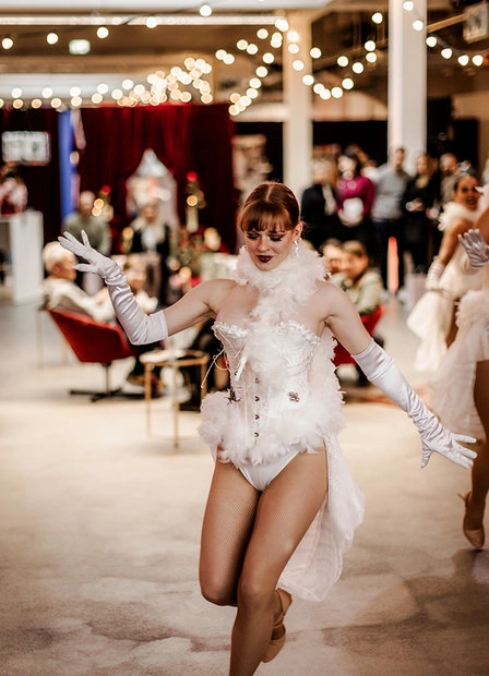 Bride in a white dress walking the runway at a fashion show
