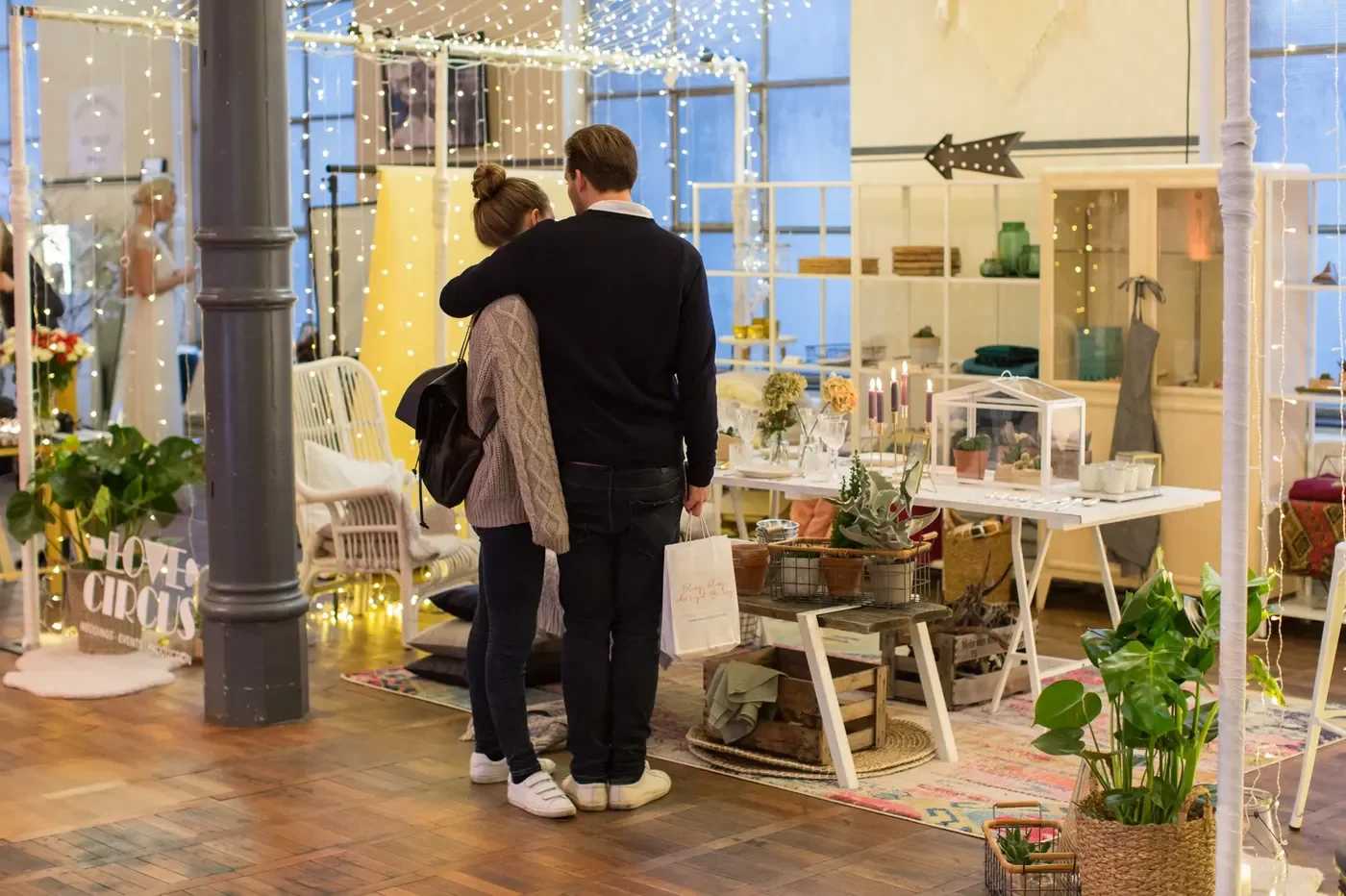 Visitors looking at an exhibition stand in a bright room