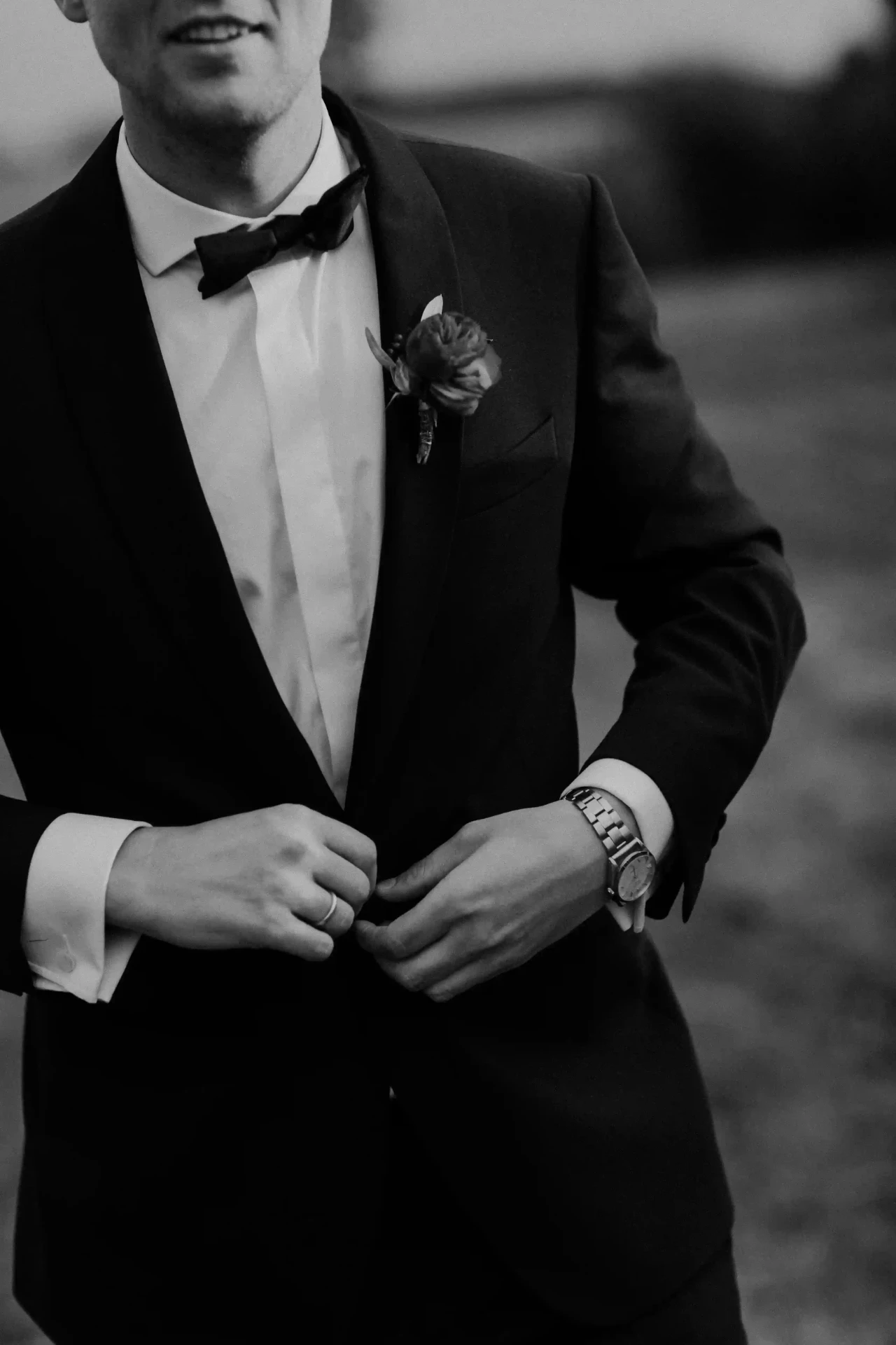 Groom adjusting his suit