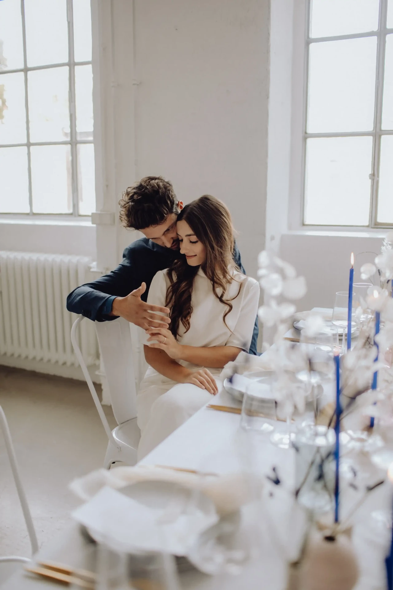 Wedding couple seated opposite each other at the wedding table
