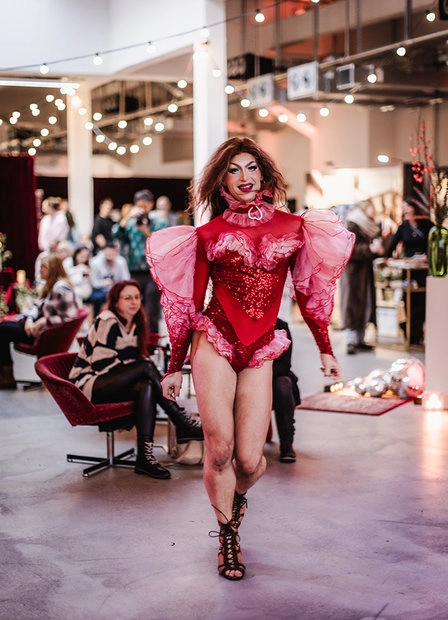 Model in a pink outfit walking the runway