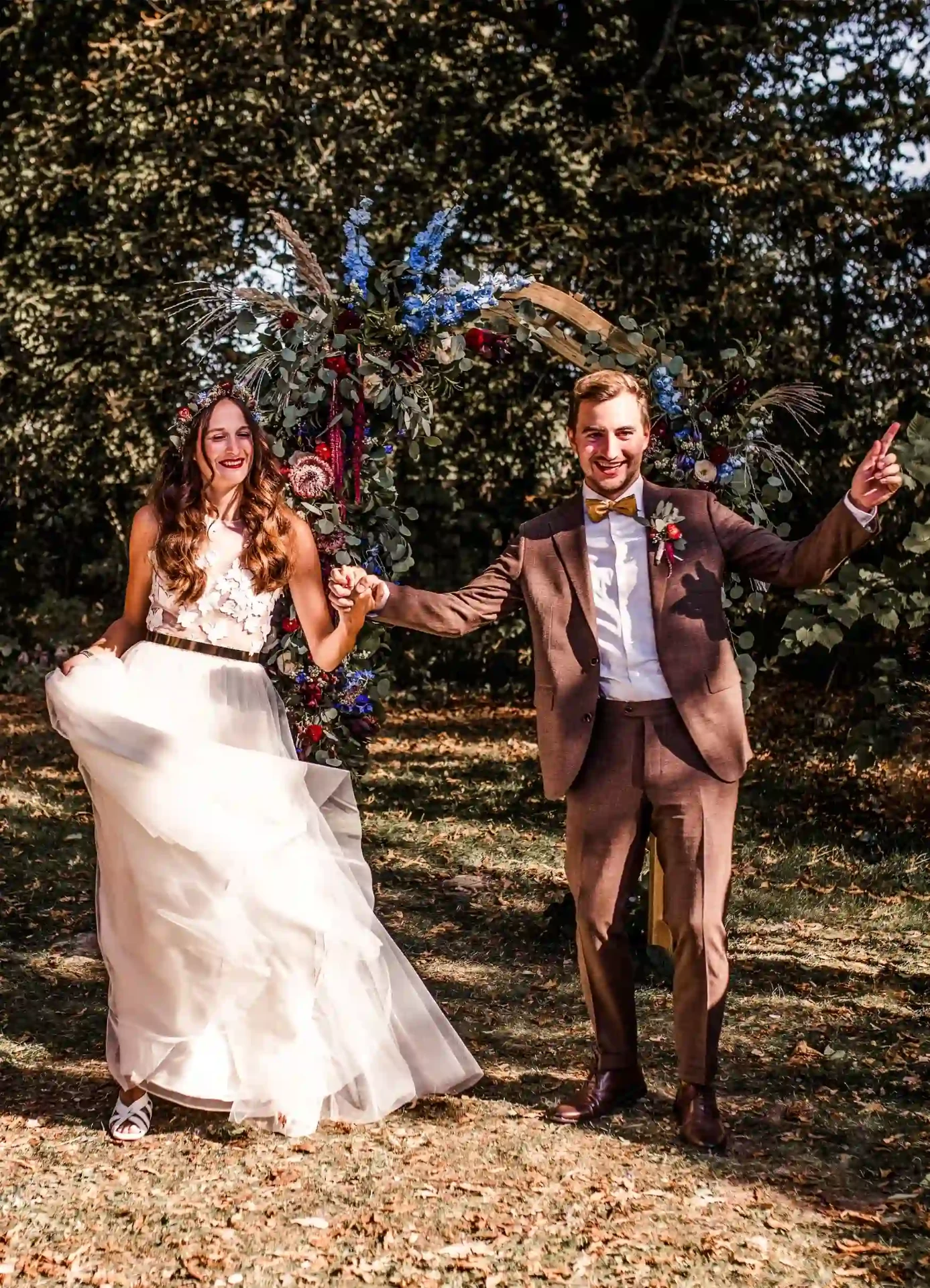 Bride and groom walking together through the garden