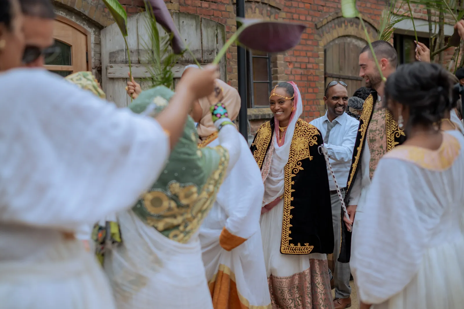 Wedding guests taking part in an outdoor traditional ceremony