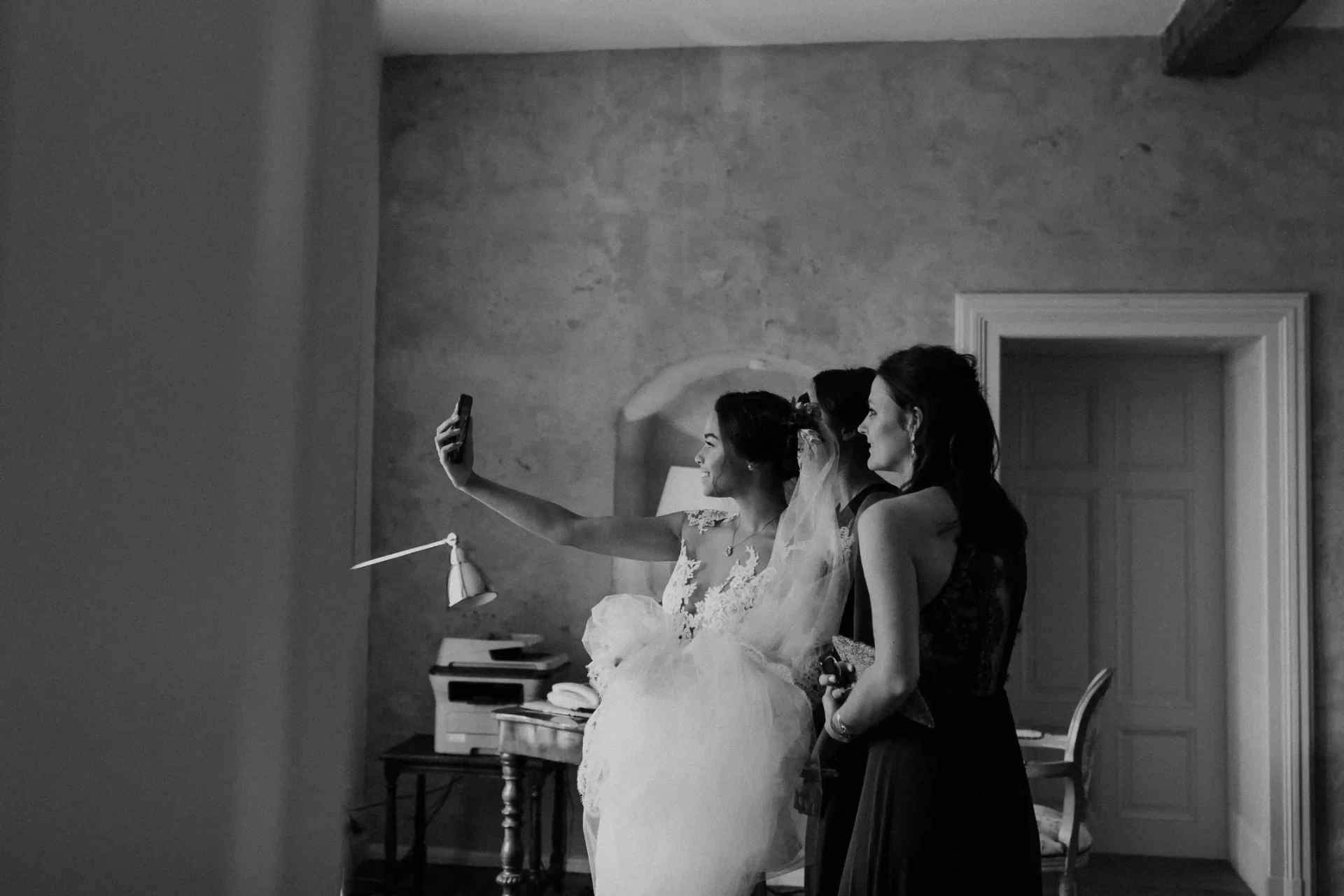 Bride with attendants in a bright room