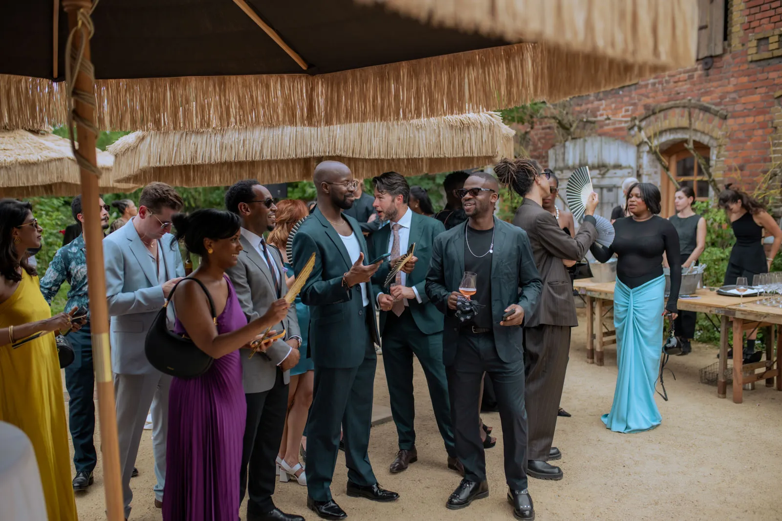 Wedding guests and musicians gathered beneath a rustic wooden roof