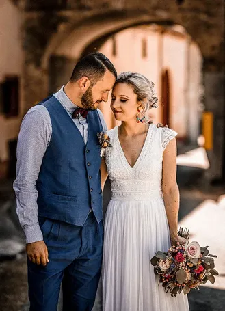 Bride and groom standing in a courtyard