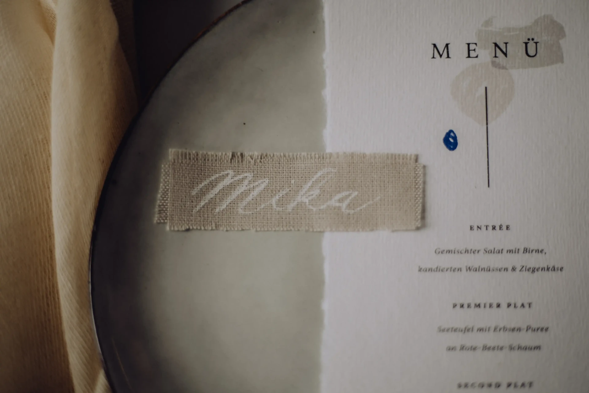 Wedding stationery on a light surface with a blue detail