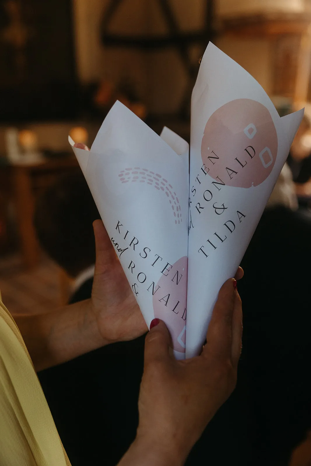 Hands holding a folded sheet of paper