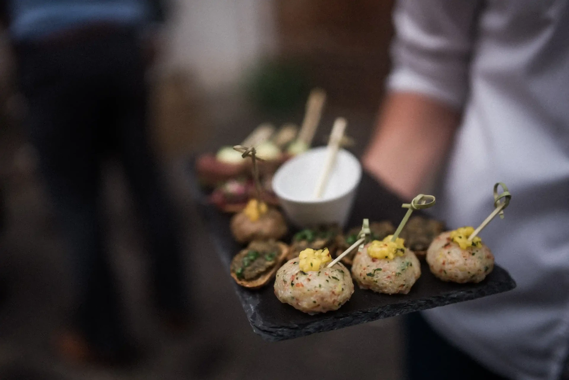 Small bites being served on a tray